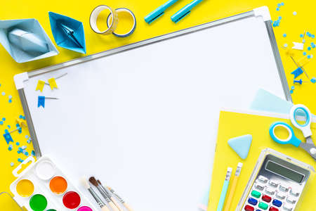 School colorful stationery on yellow background with copyspace