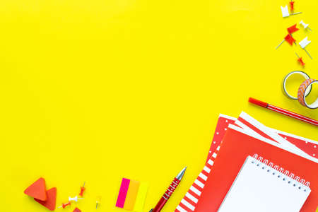School colorful stationery on yellow background with copyspaceの写真素材