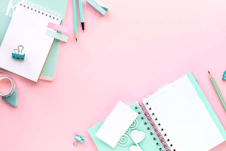 Various colorful stationery for school and office on pink background with copyspace.の写真素材