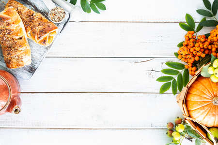 Baking with pumpkin and cinnamon on a white wooden background. Top view, rustic style, copy space.