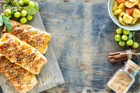 Baking with apple, Freshly baked apple and cinnamon rolls made from puff pastry on a white wooden...
