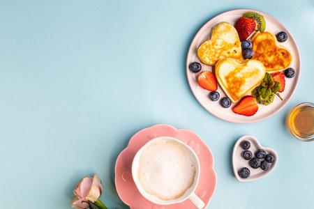 Valentines day flat lay with heart shaped pancakes on a blue background. Valentines Day concept. View from above. Copy spaceの写真素材