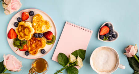 Valentines day flat lay with heart shaped pancakes on a blue background. Valentines Day concept. View from above. Bannerの写真素材