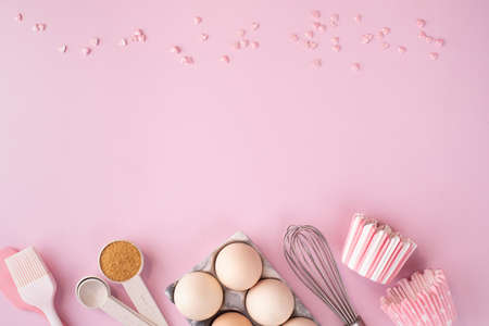 Frame of food ingredients for baking on gently pink pastel background. Cooking flat lay with copy space. Tの写真素材
