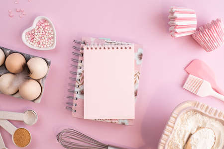 Frame of food ingredients for baking on gently pink pastel background. Cooking flat lay with copy space. Tの写真素材
