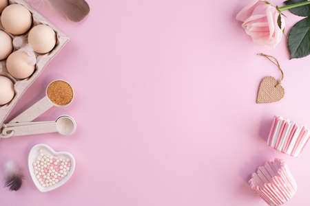 Frame of food ingredients for baking on gently pink pastel background. Cooking flat lay with copy space. Top view. Baking concept. flat layの写真素材