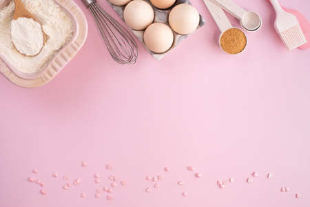 Frame of food ingredients for baking on gently pink pastel background. Cooking flat lay with copy space. Top view. Baking concept. flat layの写真素材