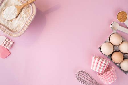 Frame of food ingredients for baking on gently pink pastel background. Cooking flat lay with copy space. Top view. Baking concept. flat layの写真素材