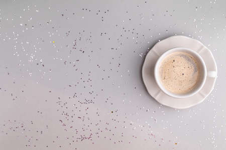 Cup of coffee on a festive gray background. Flat style. Copy space. View from above.の写真素材