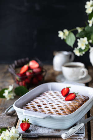 Tasty berry pie with strawberries on wooden table. Verticalの写真素材