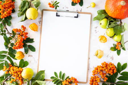 Autumn flat lay with a blank sheet of paper for writing. Copy space, top view.の写真素材