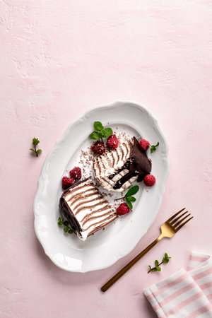 Pancake chocolate cake with fresh raspberries on a pink background. Chocolate dessert.の写真素材