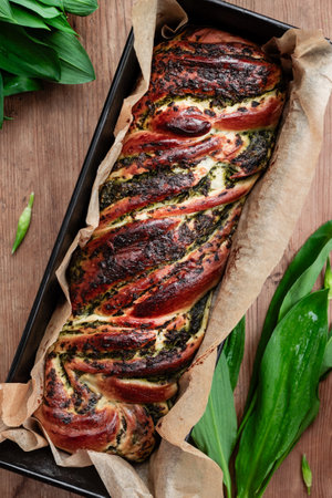 Homemade bread with wild garlic pesto on a wooden background. Top viewの写真素材