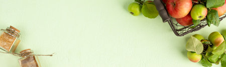 Bag with red apples on a light green background, top viewの写真素材