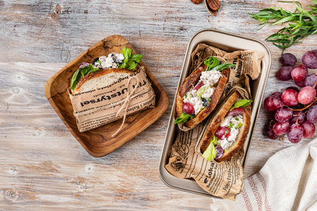 Sandwiches with chicken salad, grapes, tarragon and pecans on a wooden table. Top viewの写真素材