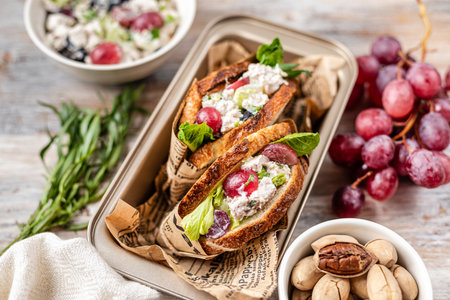 Salad with chicken breast, tarragon, pecans and grapes. Wooden backgroundの写真素材