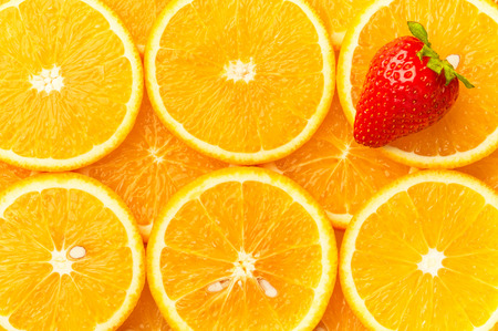 Fresh orange slices with strawberry, backgroundの写真素材