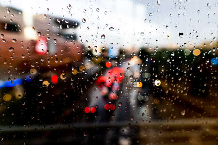 Raindrops on the window with blurry traffic backgroundの写真素材
