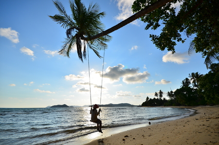 Girl on Swing at Sunset Beachの写真素材