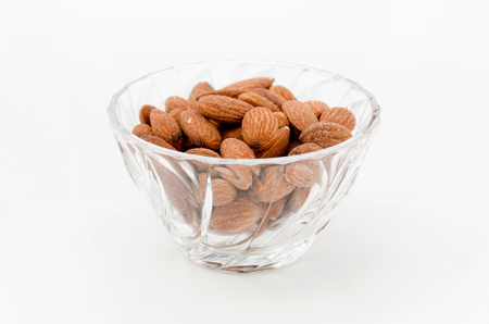group of almonds in Glass container isolated white backgroundの写真素材