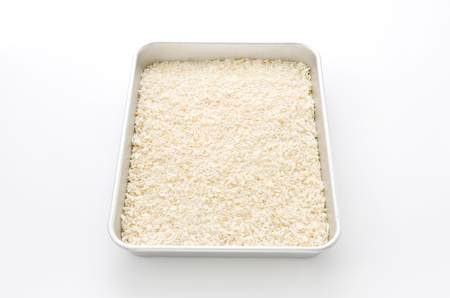 spread breadcrumbs over aluminum trayの写真素材