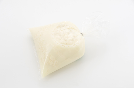 Japanese Food, Yushi tofu, tofu fluffy (Okinawa's regional cuisine) in Plastic bag on white backgroundの写真素材