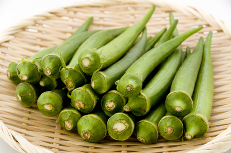 fresh okra on bamboo sieveの写真素材