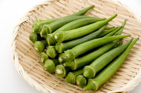 fresh okra on bamboo sieveの写真素材