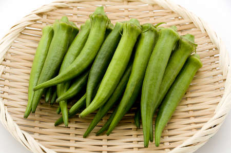 fresh okra on bamboo sieveの写真素材