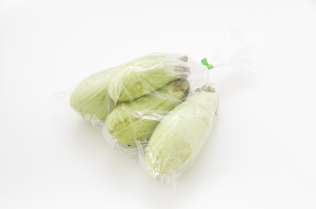 Green eggplant in a Plastic bag on white backgroundの写真素材
