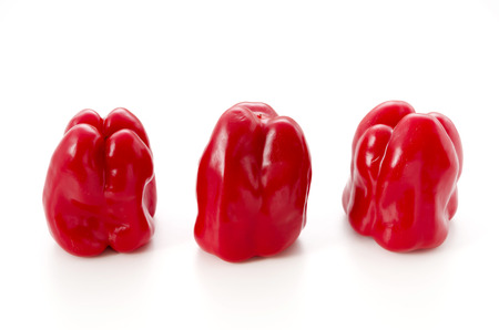 Three Red bell peppers isolated on white backgroundの写真素材