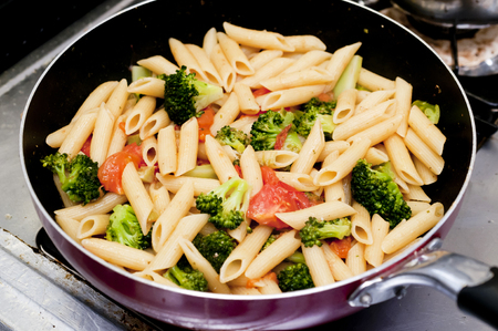 Pasta penne with broccoli, tomato, in a skillet,の写真素材