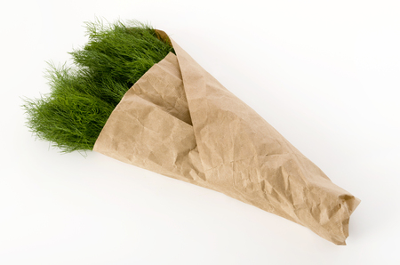 Fennel wrapped in craft paper on white backgroundの写真素材