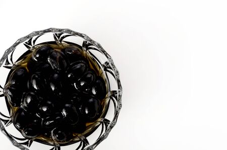 boiled black beans in glass bowl on white backgroundの写真素材
