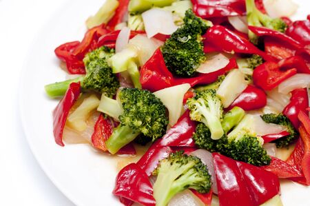 Stir fry Red Bell Pepper and broccoli onion on white plateの写真素材