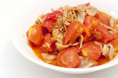Chicken Tomato Stir Fry on white backgroundの写真素材
