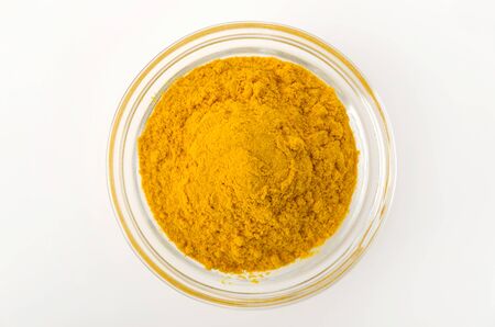 Turmeric powder in Glass Bowl on white backgroundの写真素材