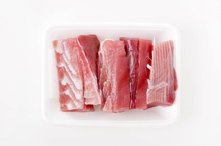 "Maguro no ara" Raw tuna fillet in the foam tray on White Background.の写真素材