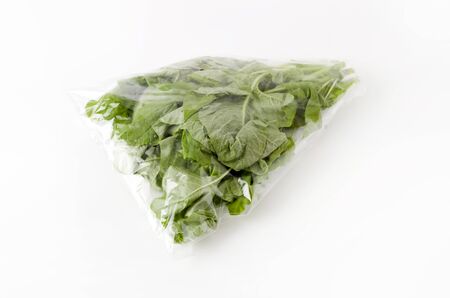 Amaranthus leaves in plastic bag on white backgroundの写真素材