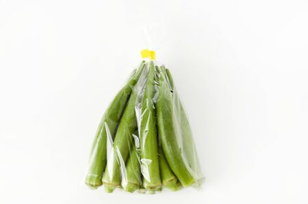 fresh Okra in plastic bag on white backgroundの写真素材