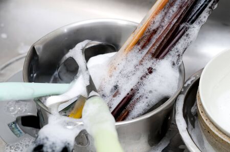 Wash dishes, Wash kitchen ware on the sinkの写真素材