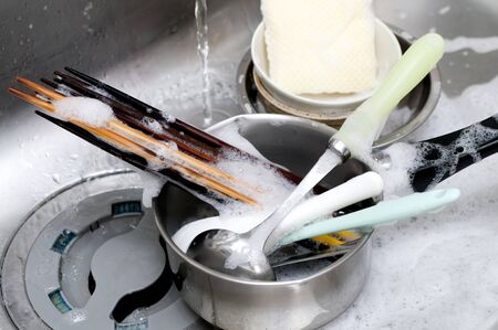 Wash dishes, Wash kitchen ware on the sinkの写真素材