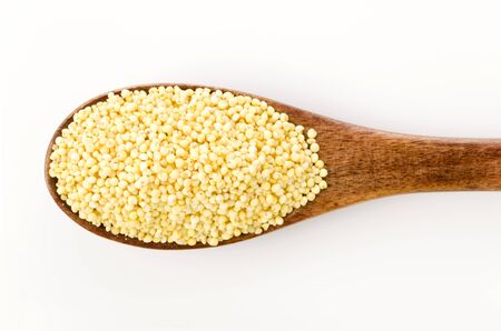 Glutinous Millet in wooden spoon on white backgroundの写真素材