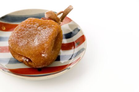 Dried persimmon on a plate white backgroundの写真素材