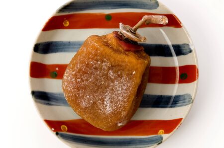 Dried persimmon on a plate white backgroundの写真素材