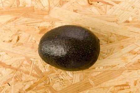 Avocado on OSB plywood board background