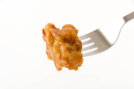 Japanese food, tori karaage, Fried chicken on a fork on white backgroundの写真素材