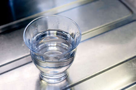 glass of water on kitchen sink