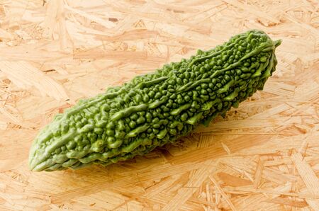fresh Goya, Bitter Melon on a plywood board backgroundの写真素材