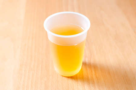 Tea in a plastic cup on tableの写真素材